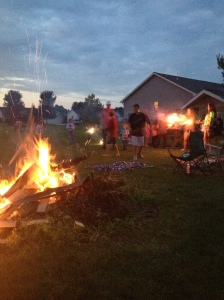 Kids playing with sparklers and bonfire. 